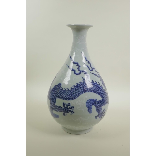 18 - A Chinese blue and white porcelain pear shaped vase decorated in the Ming style depicting dragons ch... 