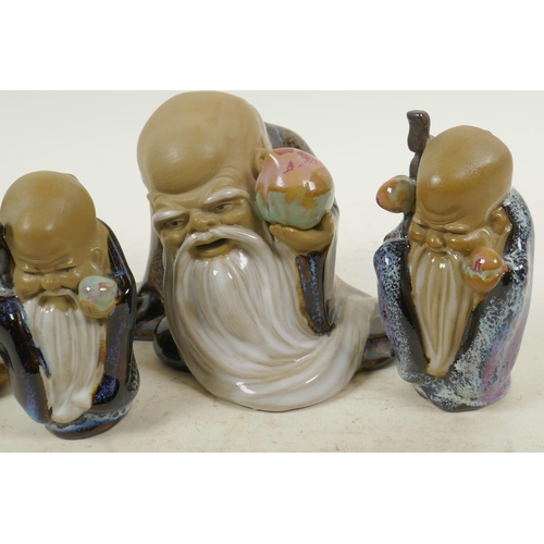 21 - Four Chinese, Shiwan style, mud men shaven head pilgrim figures, 4½