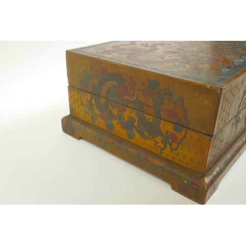 40 - A Chinese lacquer box with engraved and painted decoration of dragons chasing the flaming pearl, 12