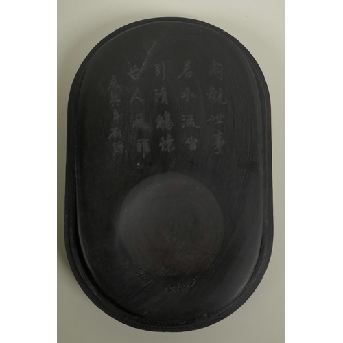 45 - A Chinese boxed inkstone with an engraved inscription, the cover with inset figural decoration, 10