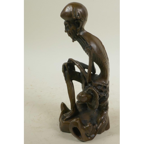 46 - A bronze figure of a skeletal man, 8½