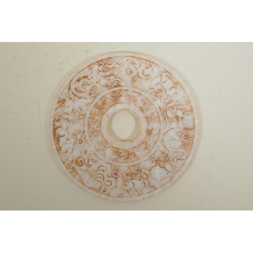 5 - A Chinese hardstone pi disc with moulded Zodiac animal and character inscriptions, 8