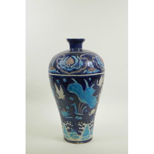 53 - A Chinese Fahua pottery meiping vase decorated with birds amongst a lotus pond, 14