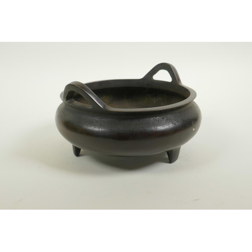 55 - A Chinese bronze censer on tripod supports with phoenix eye handles, impressed seal mark to base, 7