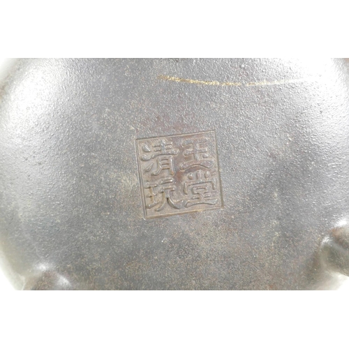 55 - A Chinese bronze censer on tripod supports with phoenix eye handles, impressed seal mark to base, 7