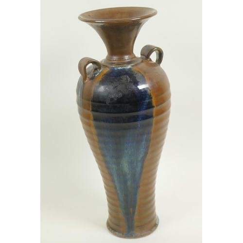 7 - A Chinese stoneware baluster vase with rib formed body and two loop handles, drip glazed in brown an... 