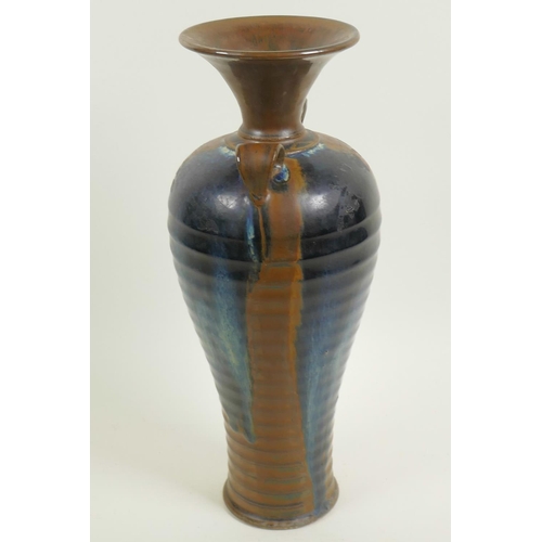 7 - A Chinese stoneware baluster vase with rib formed body and two loop handles, drip glazed in brown an... 