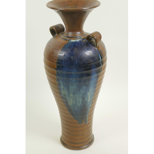 7 - A Chinese stoneware baluster vase with rib formed body and two loop handles, drip glazed in brown an... 