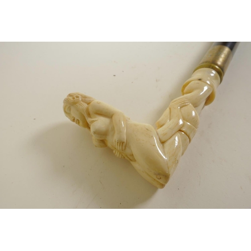 10 - A hardwood walking stick with bone handle carved as erotic figures, 36