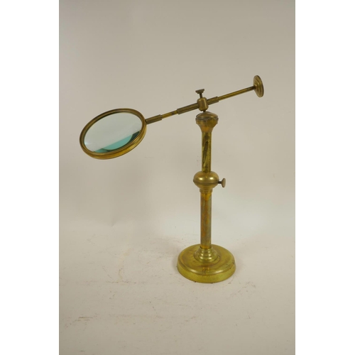 14 - An adjustable, brass table top magnifying glass, lens 4