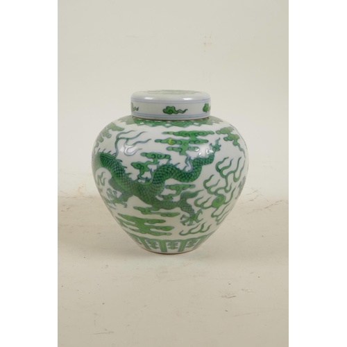 15 - A Chinese Ming style porcelain ginger jar and cover with green enamel dragon and flaming pearl decor... 