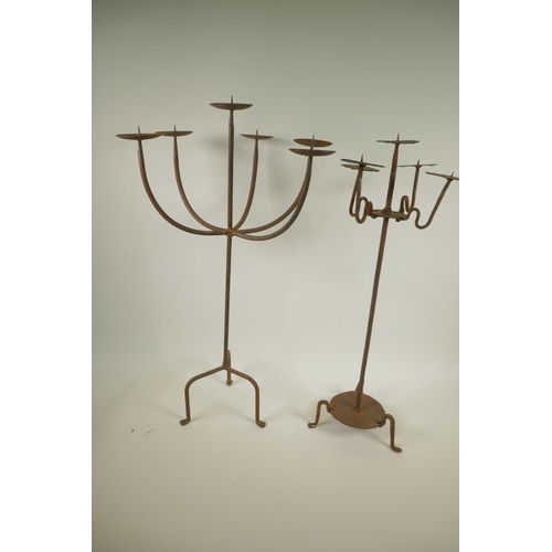 16 - A wrought iron six light pricket candlestick, A/F, together with a smaller five light pricket candle... 