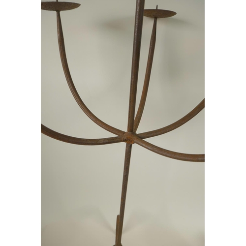 16 - A wrought iron six light pricket candlestick, A/F, together with a smaller five light pricket candle... 