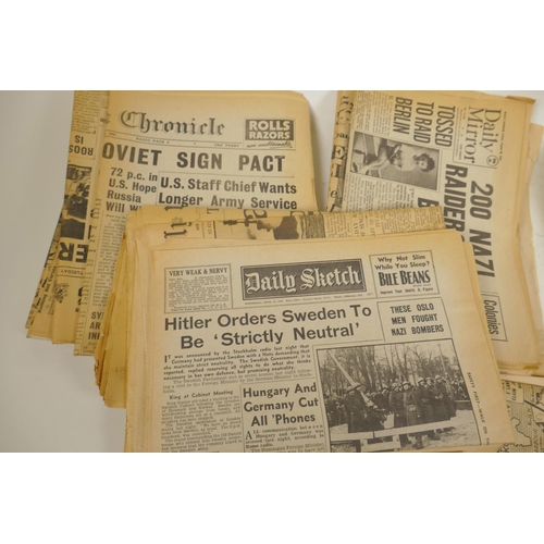 17 - A quantity of WWII era newspapers and three posters