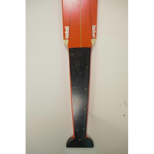 19 - A painted wood height measure in the form of a guard in ceremonial dress including busby, 48