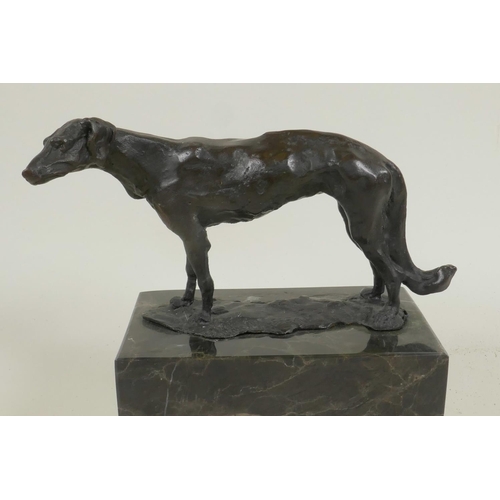 25 - A bronze figure of a Borzoi hound mounted on a marble plinth, 6¼