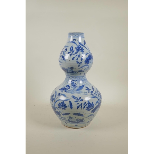 28 - A Yuan style blue and white double gourd vase with crane and lotus flower decoration, 13