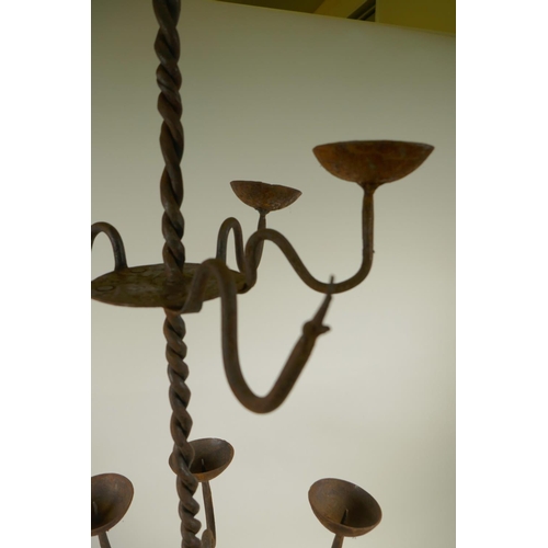 4 - A wrought iron fifteen branch standing candlestick with twisted stem, A/F, 45