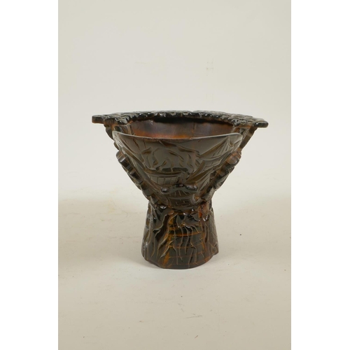 40 - A Chinese sectional horn libation cup with carved decoration of figures in a forest, 4½