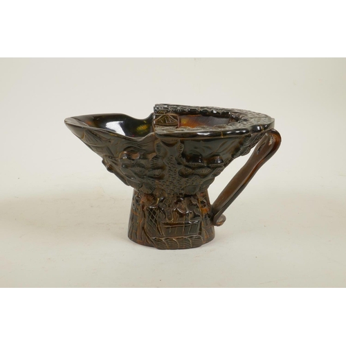 40 - A Chinese sectional horn libation cup with carved decoration of figures in a forest, 4½