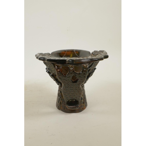 40 - A Chinese sectional horn libation cup with carved decoration of figures in a forest, 4½