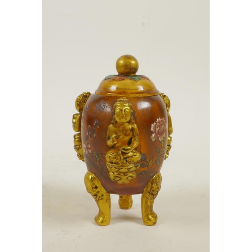 43 - A Peking glass censer and cover on tripod supports with three raised and gilt depictions of Buddha a... 