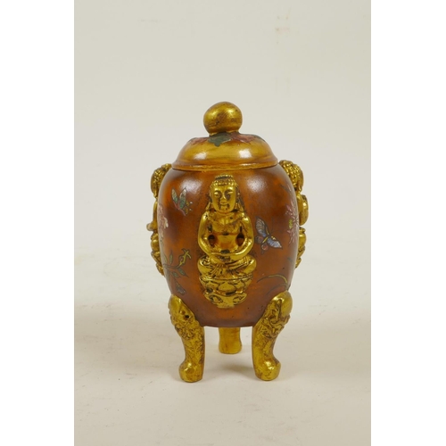 43 - A Peking glass censer and cover on tripod supports with three raised and gilt depictions of Buddha a... 