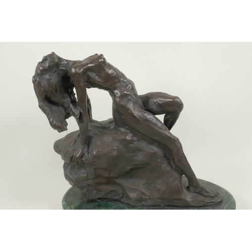 45 - A stylised bronze figure of a nude female posed on a rock, 11