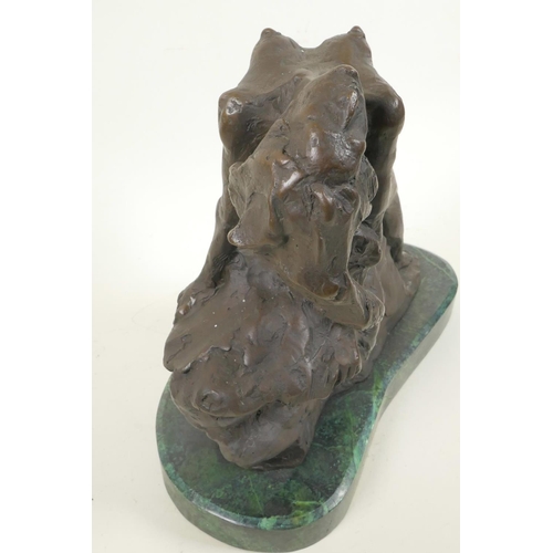 45 - A stylised bronze figure of a nude female posed on a rock, 11