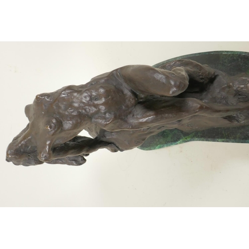 45 - A stylised bronze figure of a nude female posed on a rock, 11