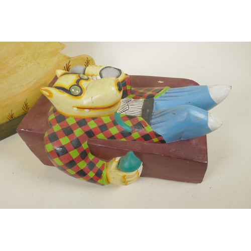 46 - A pop art carved wood figure of a dog lounging on a settee painted in bright colours, 12