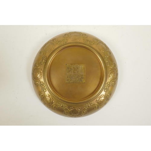 48 - A Chinese bronze bowl with raised decoration of Buddha and eighteen Lohan, impressed seal mark to ba... 