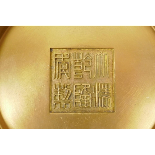 48 - A Chinese bronze bowl with raised decoration of Buddha and eighteen Lohan, impressed seal mark to ba... 