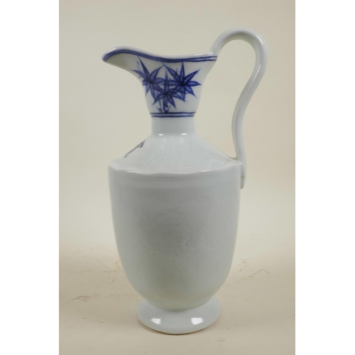 50 - A Chinese blue and white porcelain jug with incised auspicious fruit decoration, 2 character mark to... 