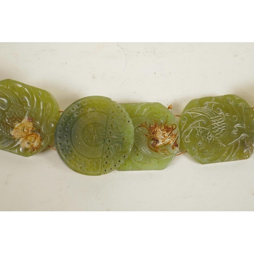 55 - A Chinese green jade belt, with carved decoration to each panel depicting a phoenix, 40