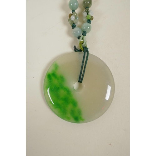 8 - A Chinese green and white jadeite pendant/toggle in the form of a pi-disc, 2