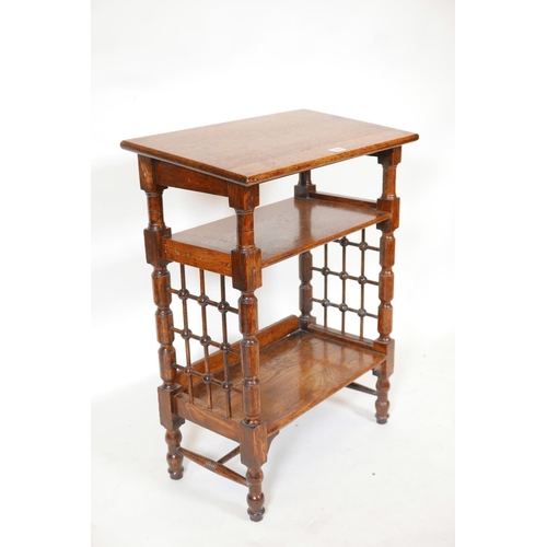 1138 - A Liberty & Co. Arts and Crafts three tier book stand with turned lattice work sides, 23