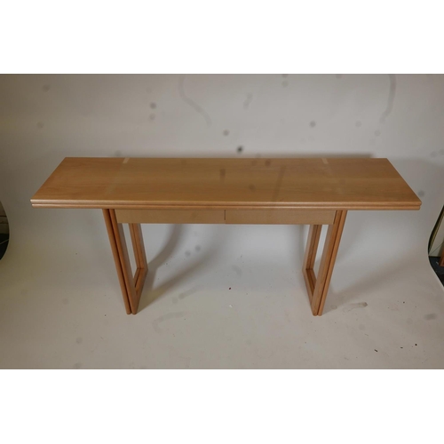 1256 - A contemporary blond ash side table with fold out leaf and two drawers, 63