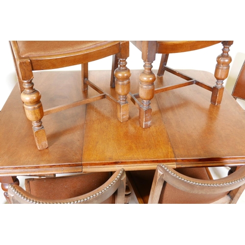 1147 - A Victorian mahogany wind out dining table on turned and carved legs, with a single leaf, and six oa... 