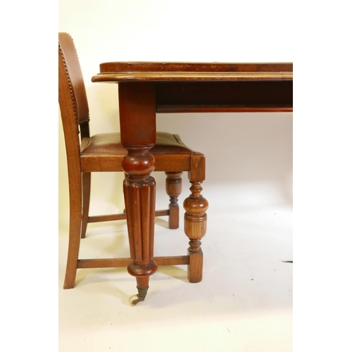 1147 - A Victorian mahogany wind out dining table on turned and carved legs, with a single leaf, and six oa... 