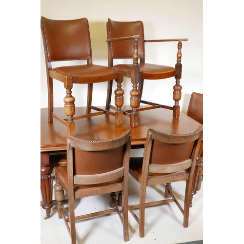 1147 - A Victorian mahogany wind out dining table on turned and carved legs, with a single leaf, and six oa... 