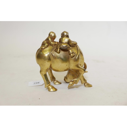 401 - A gilt bronze figure of two boys riding a water buffalo, 6