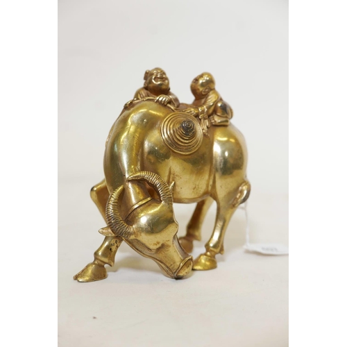 401 - A gilt bronze figure of two boys riding a water buffalo, 6