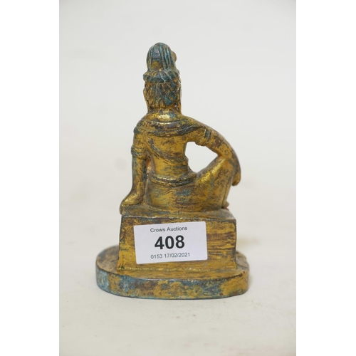 421 - A bronze figure of a seated Buddhistic figure, with worn gilt patination, 5