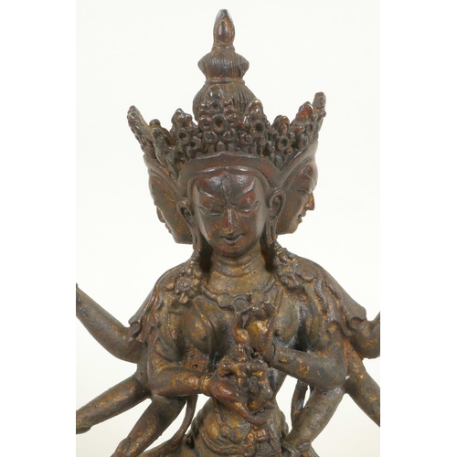 379 - A bronze Buddhistic figure with eight arms, seated upon a lotus throne, pendant 2