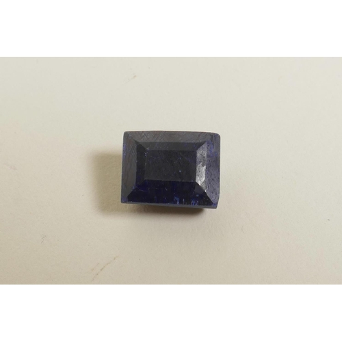 718 - A 10.70ct natural blue sapphire, rectangular step cut, colour enhanced, certified by Gemological Lab... 