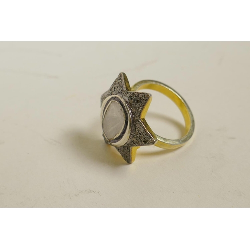 726 - A silver gilt dress ring in the form of a star, encrusted with uncut diamonds