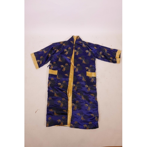 10 - A Chinese blue silk robe decorated with auspicious symbols and assorted vessels, 50