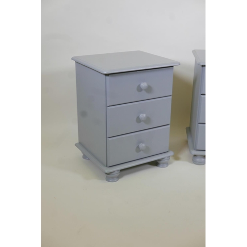 1010 - A pair of painted pine three drawer bedside chests, 17