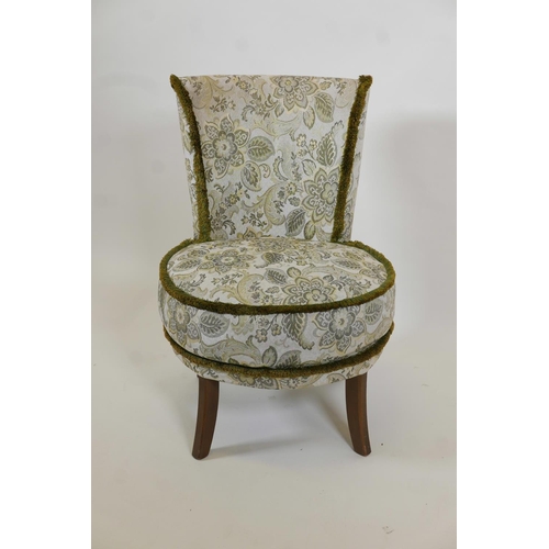 1011 - A Victorian nursing chair upholstered in green brocade